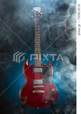 electric guitar in smoke, blue background electric guitar in smoke, blue background 76961610