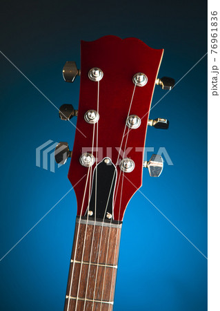 electric guitar head, blue background electric guitar head, blue background 76961836