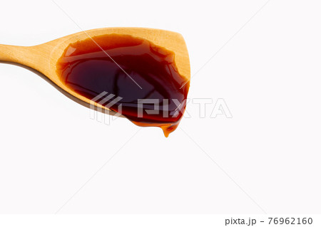 Wooden spatula with oyster sauce on white 76962160