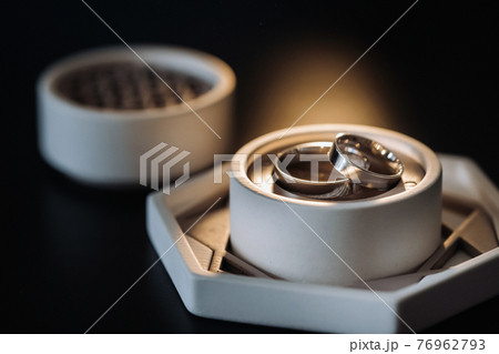 two gold wedding rings in a white box on a black background two gold wedding rings in a white box on a black background 76962793