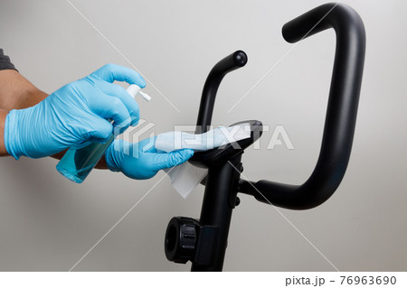 Gym cleaning and disinfection Infection prevention Cleaning covid cleaning spray bottle washing surfaces with towel and gloves. COVID-19 Gym cleaning and disinfection Infection prevention Cleaning covid cleaning spray bottle washing surfaces with towel and gloves. COVID-19 76963690