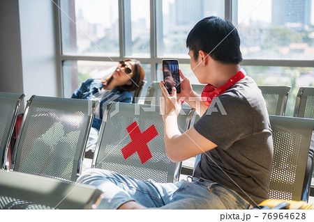 Man photo his sleeping friend at airport waiting seats Man photo his sleeping friend at airport waiting seats 76964628