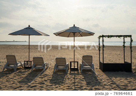Bed chairs and parasols on beach. Summer holiday Bed chairs and parasols on beach. Summer holiday 76964661