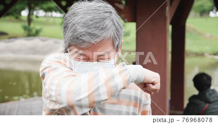 Asian man cough in elbow Asian man cough in elbow 76968078