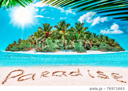 Whole tropical island within atoll in tropical Ocean and inscription "Paradise" in the sand on a tropical island. Whole tropical island within atoll in tropical Ocean and inscription "Paradise" in the sand on a tropical island. 76971663