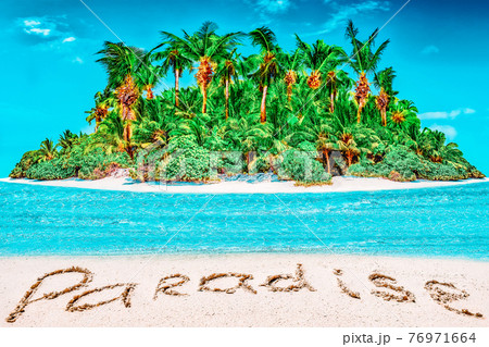 Whole tropical island within atoll in tropical Ocean and inscription "Paradise" in the sand on a tropical island. Whole tropical island within atoll in tropical Ocean and inscription "Paradise" in the sand on a tropical island. 76971664