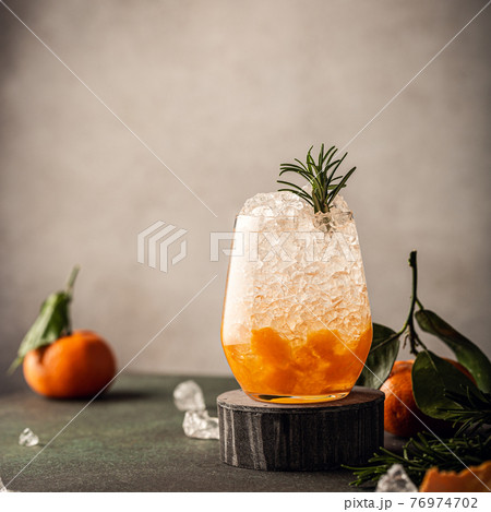 Fresh cocktail with crushed ice, rosemary and tangerines Fresh cocktail with crushed ice, rosemary and tangerines 76974702