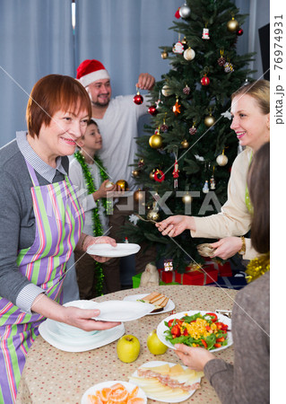 Family preparing for Christmas party at home Family preparing for Christmas party at home 76974931