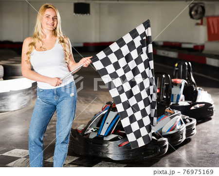 Portrait of pretty girl holding finish flag Portrait of pretty girl holding finish flag 76975169