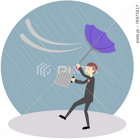 風に飛ばされそうなオフィスワーカー（男性） 76975617