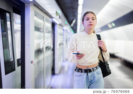 Young european female with mobile waiting the metro Young european female with mobile waiting the metro 76976066