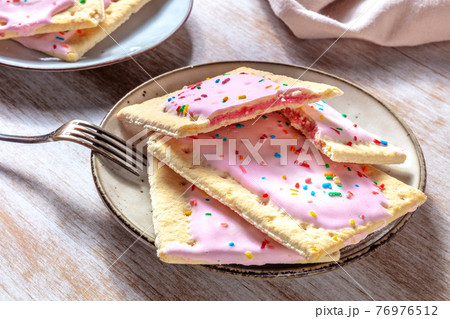 Strawberry pop tarts on a plate on a wooden table 76976512