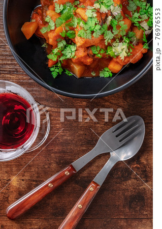 The cuisine of Portugal. Alentejo style pork with a glass of sweet porto wine The cuisine of Portugal. Alentejo style pork with a glass of sweet porto wine 76976553