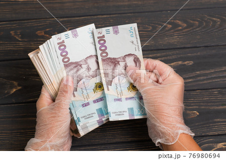 Stack of ukrainian hryvnia banknotes in hands 76980694