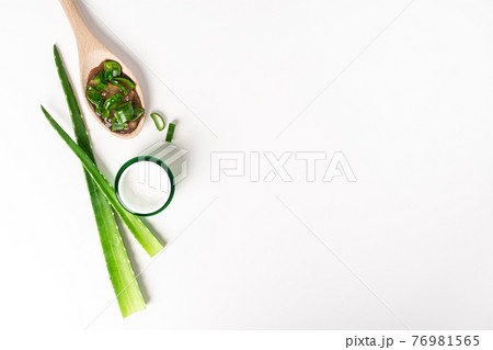 Top view with aloe vera juice, organic cream, gel, towel and green leaves. 76981565