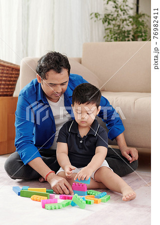 Kid and son playing together Kid and son playing together 76982411