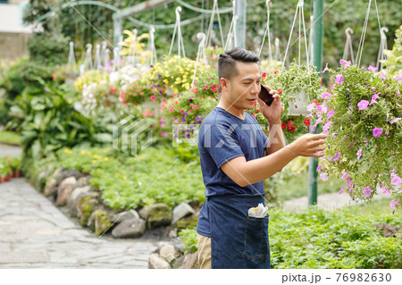 Greenhouse worker calling customer 76982630