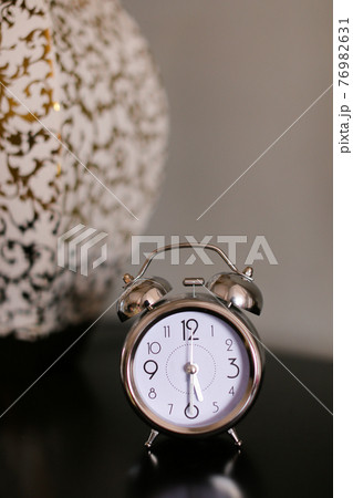 Antique clock in black background. 76982631