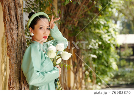 Beautiful woman with lotus flowers Beautiful woman with lotus flowers 76982870
