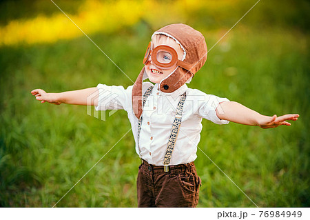 A little boy dreams of becoming a pilot. Vintage aviation hat A little boy dreams of becoming a pilot. Vintage aviation hat 76984949