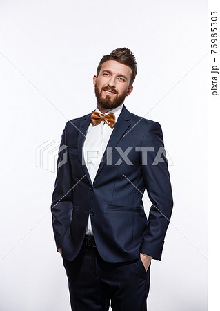 Elegant young handsome man in black classic costume. Studio fashion portrait. Elegant young handsome man in black classic costume. Studio fashion portrait. 76985303