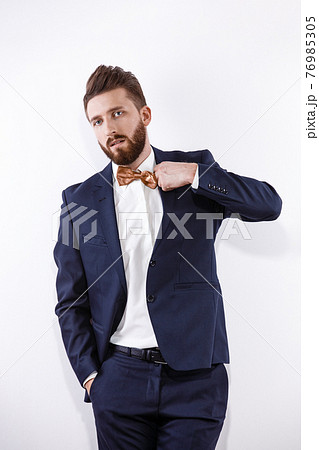 Elegant young handsome man in black classic costume. Studio fashion portrait. Elegant young handsome man in black classic costume. Studio fashion portrait. 76985305