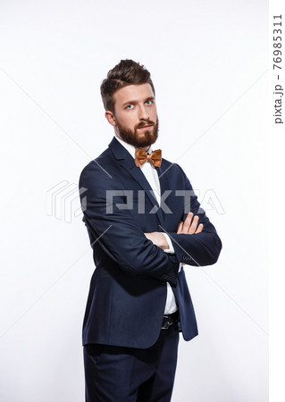 Elegant young handsome man in black classic costume. Studio fashion portrait. Elegant young handsome man in black classic costume. Studio fashion portrait. 76985311