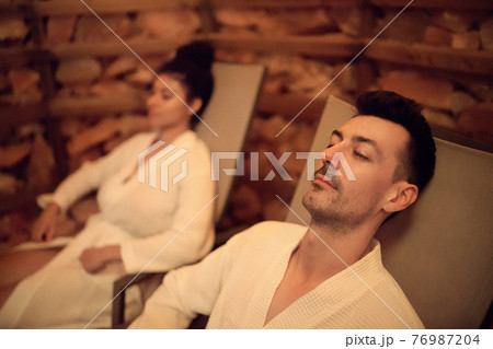 Portrait of young couple in salt inhalation steam room, relaxing. 76987204