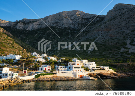 Kamares town with traditional white houses on Sifnos island on sunset. Greece 76989290