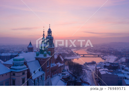 Wawel Royal Castle in winter. Snow on roofs of Wawel castle cathedral and Vistula river 76989571