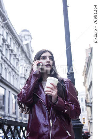 young pretty girl outside in city street with coffee happy smiling, lifestyle fashion peopple concept 76991264