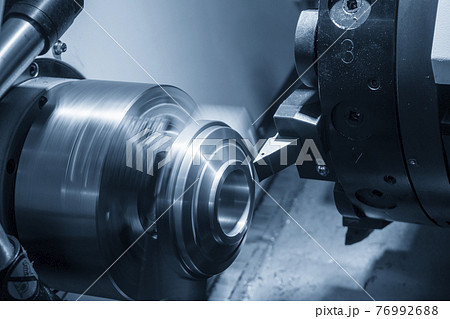 The CNC lathe machine cutting the metal plate parts. The CNC lathe machine cutting the metal plate parts. 76992688