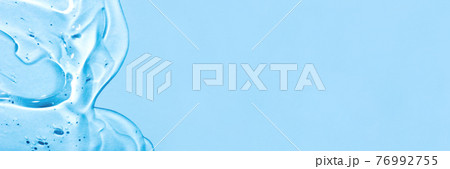 Transparent hyaluronic acid gel on a blue background. Transparent hyaluronic acid gel on a blue background. 76992755