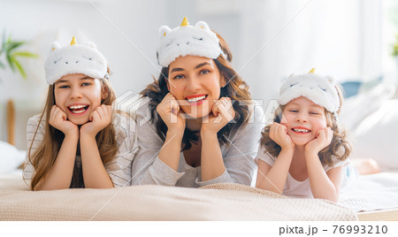 girls and their mother enjoying sunny morning girls and their mother enjoying sunny morning 76993210