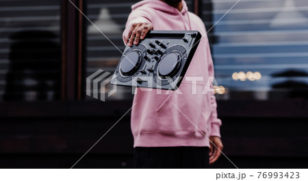 male hands holding dj mixer 76993423