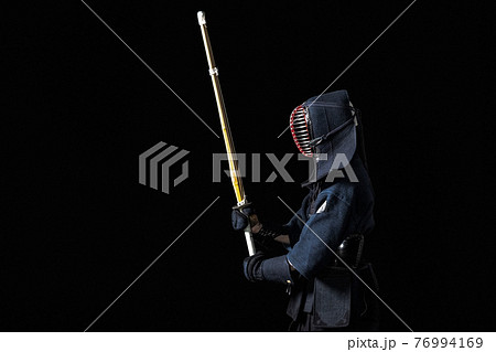 Kendo fighter with with shinai 76994169
