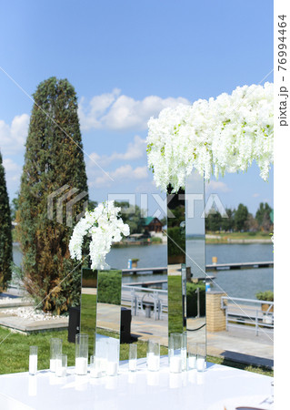 White wonderful wedding arch with lake in backround. White wonderful wedding arch with lake in backround. 76994464