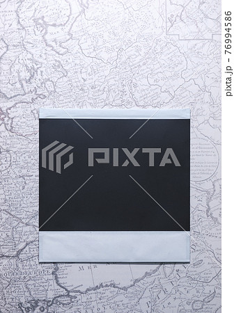 Top View of photo frame on map, Memory of a trip or adventure. Photo card with space for your logo or text. 76994586