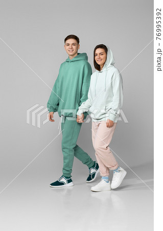 young couple wearing mint green casual hoodie 76995392