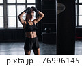 young girl stands in an atmospheric fitness room against the background of lockers for changing room 76996145
