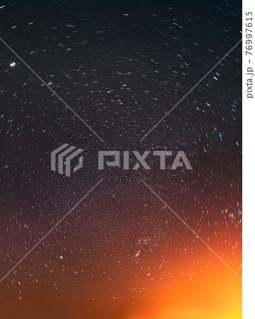 Night Sky Glowing Stars Background Backdrop In Rotation. Colorful Sky Gradient. Sunset Sunrise Light And Colourful Night Starry Sky In Yellow Orange Black Colors. Copy Space 76997615