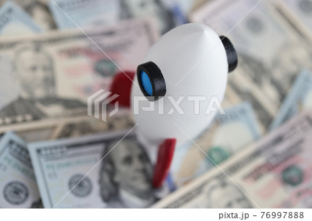 There are American bills and rocket on table. There are American bills and rocket on table. 76997888