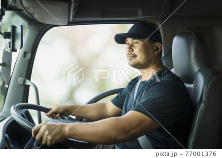 Truck driver is driving a transport vehicle. 77001376