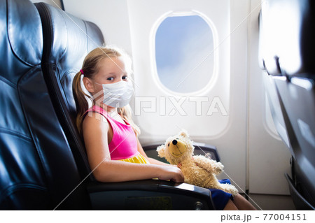 Child in airplane in face mask. Virus outbreak. 77004151
