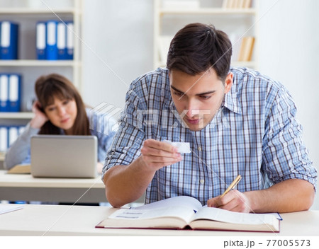 Students sitting and studying in classroom college 77005573