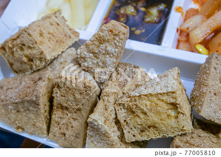 Stinky tofu, a close up of Taiwanese traditional deep fried beancurd street food at Taipei night market in Taiwan. 77005810