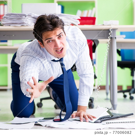 Frustrated businessman stressed from excessive work 77006082