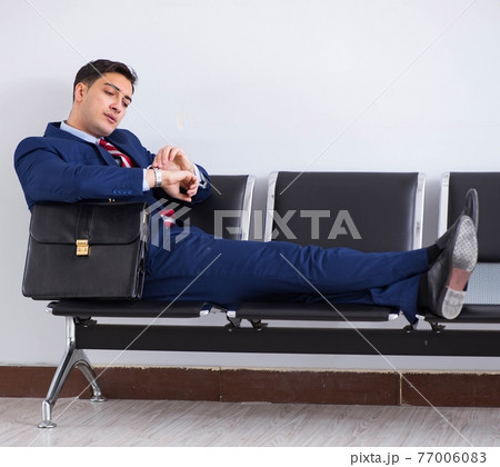 Man wairing to boarding in airport lounge room Man wairing to boarding in airport lounge room 77006083