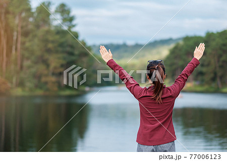 Happy traveler woman standing and looking Nature view, solo tourist in sweater traveling at Pang Oung, Mae Hong Son, Thailand. travel, trip and vacation concept 77006123