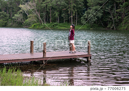 Happy traveler woman standing and looking Nature view, solo tourist in sweater traveling at Pang Oung, Mae Hong Son, Thailand. travel, trip and vacation concept Happy traveler woman standing and looking Nature view, solo tourist in sweater traveling at Pang Oung, Mae Hong Son, Thailand. travel, trip and vacation concept 77006275